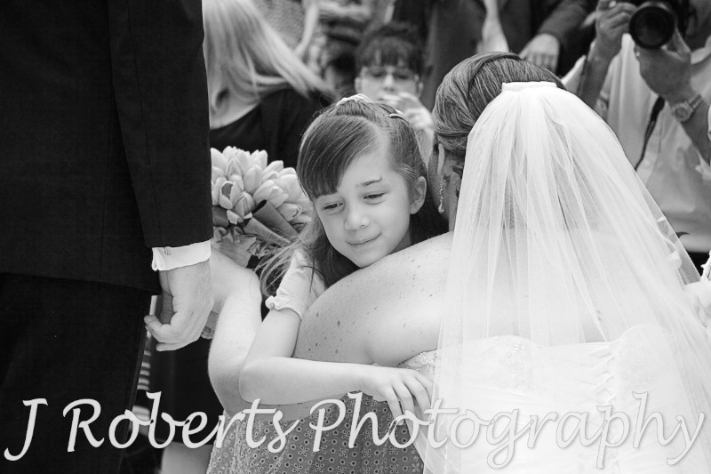 Flower girl hugging bride -wedding photography sydney